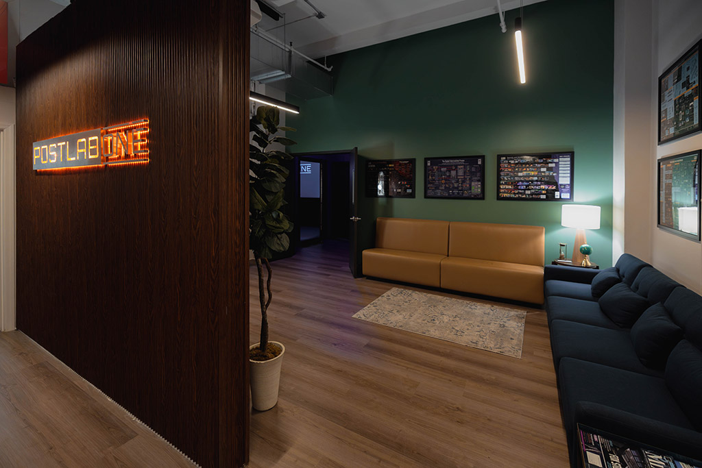 Post Lab One lounge entrance wide shot with backlit logo signage.